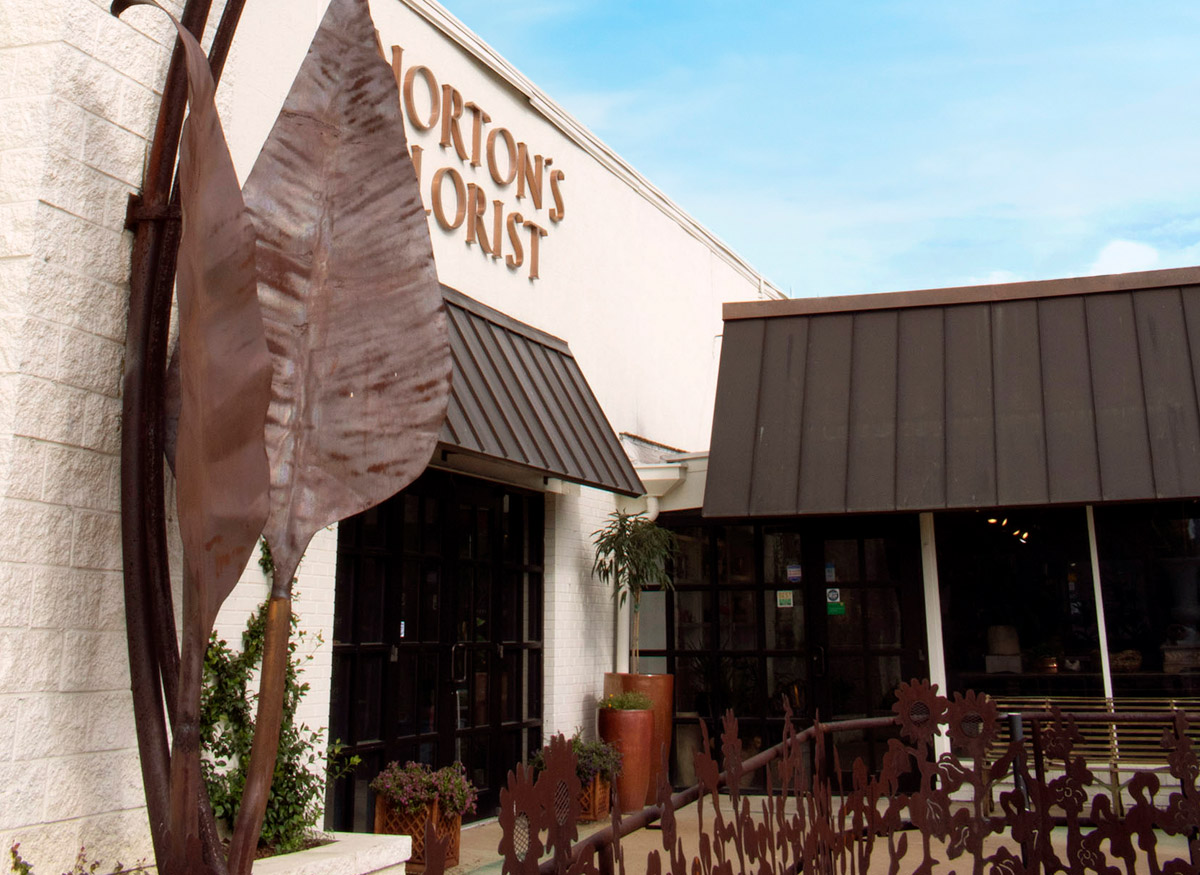 An angled exterior photo of our Birmingham storefront, with a large plant-shaped sculpture in view